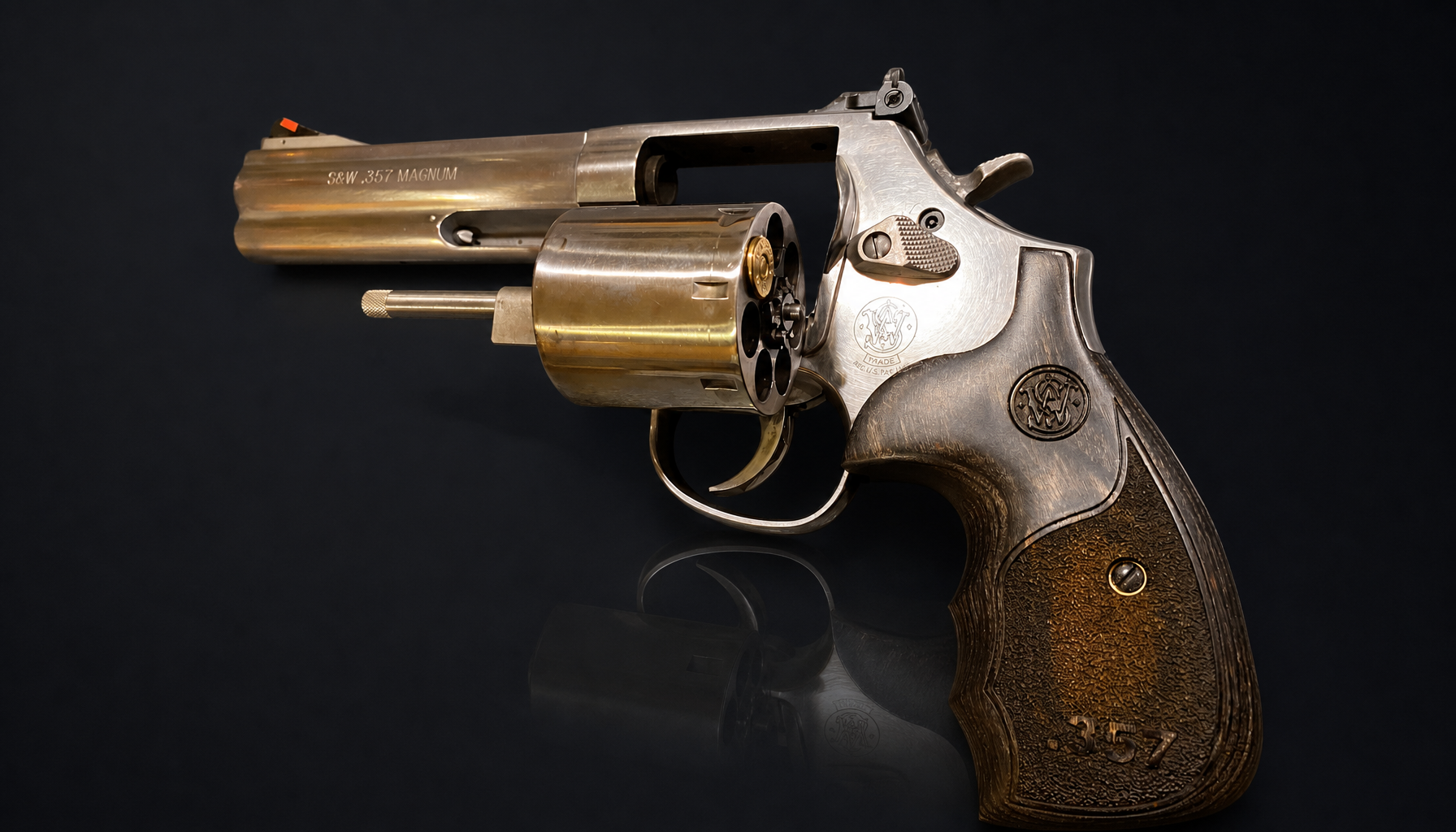 The swing-out cylinder (Colt 1889, S&W 1890s), hinged out on its crane: one push of the ejector rod clears every chamber at once.